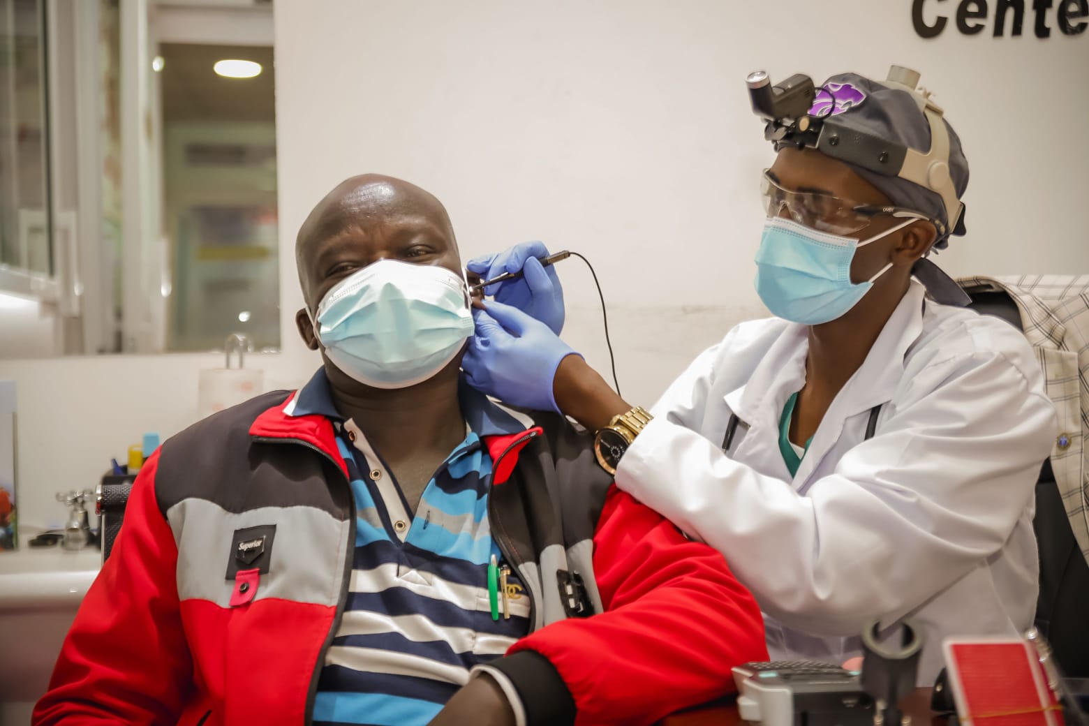 Dr. Isaac Wahome performing a professional ear check